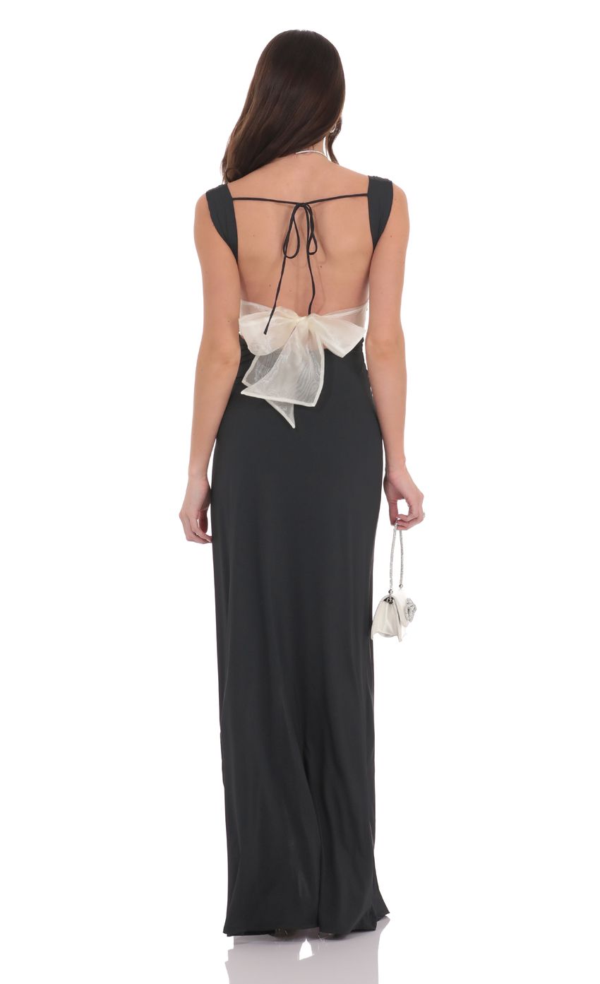Picture Open Back Bow Maxi Dress in Black. Source: https://media-img.lucyinthesky.com/data/product-media/850xAUTO/f0da9198-f317-4ce1-bd57-3c567519ca21.jpg